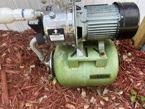 Well pump and pressure tank system inspected for PFAS in well water testing, Florida home