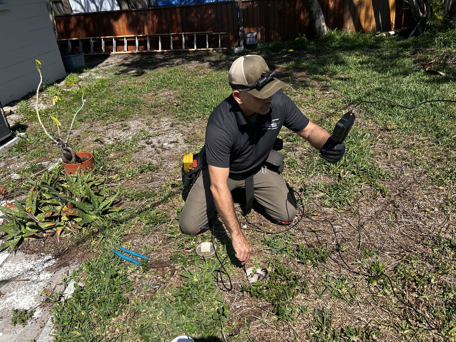 Home inspector running a sewer camera through a cleanout during a plumbing inspection in Florida
