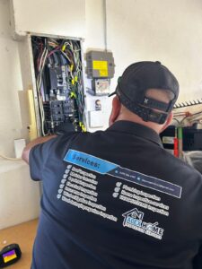 Home inspector checking an electrical panel during a Florida home inspection, the kind of finding buyers wonder is a home inspection deal breaker