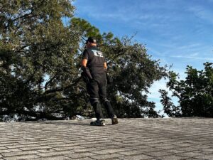 Home inspector walking a shingle roof during a wind mitigation inspection in Florida